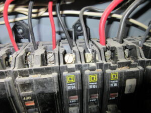 Aluminum wiring connected to breakers inside an electrical panel, showing potential electrical inspection issues in Kingston and area homes.