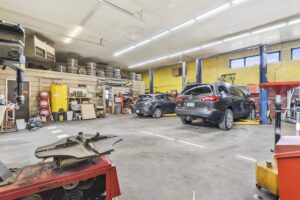Commercial auto shop interior with lifts and equipment, inspected by Rick Conley, Equinox Home Inspection Services