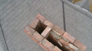 Possible deal breaker: Deteriorated chimney with missing cap and damaged masonry observed during a Kingston home inspection