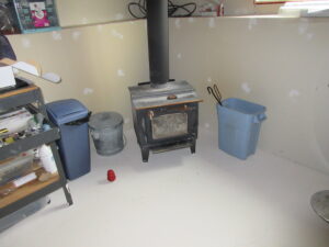 Missing heat shield exposing drywall behind a wood stove during a Kingston home inspection by Equinox Home Inspection Services